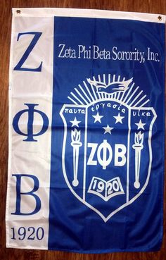 a blue and white flag with the zob logo on it is hanging from a wooden table