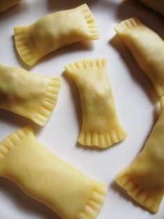 some dumplings are sitting on a plate and ready to be cooked in the oven