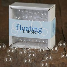 a box filled with clear bubbles on top of a wooden table