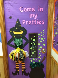 a door decorated to look like a witch with her broom in hand and the words come in my prettiies written on it