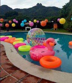 an inflatable flamingo float is sitting on the edge of a pool