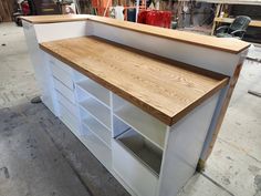 a counter made out of plywood and white cabinets