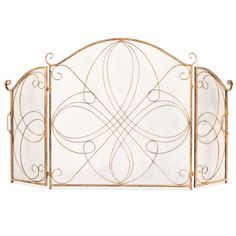 a gold metal fireplace screen with intricate designs on the top and bottom panels, set against a white background