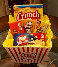 a popcorn box filled with candy and snacks