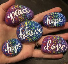 four painted rocks with the words peace, hope, hope and love written on them