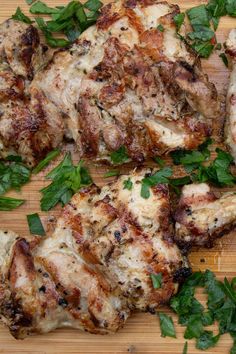 grilled chicken with herbs on a cutting board