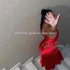 a woman in red dress standing on stairs with her hand up to her face and the words dear god, guide my steps daily