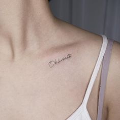 a woman with a small tattoo on her chest that reads, observante