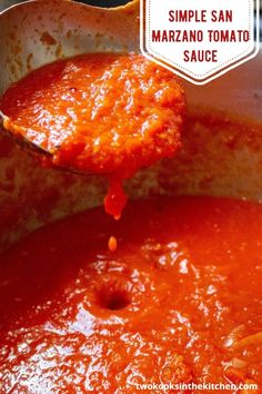 a spoon full of tomato sauce being lifted from a skillet with the words simple san marzanno tomato sauce