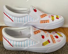 Custom teacher shoes made with a hand-painted design on memory foam slip-on sneakers. Perfect for expressing your love for teaching and showing your creative and colorful side! Custom Teacher Shoes, White Slip On Vans, Graduation Shoes, Teacher Canvas, Teacher Shoes, Painted Canvas Shoes, Teacher Fits, Slip On Vans, Women's Slip Ons