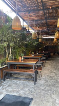 an outdoor seating area with benches and plants