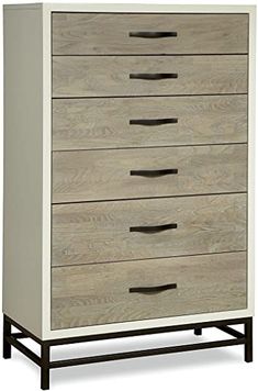 a white and wood chest of drawers with black handles on each drawer, against a white background