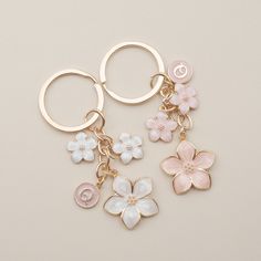 three key chains with flowers on them