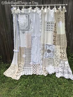 an old window curtain is covered in lace and crocheted doily on the grass