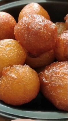 a bowl filled with oranges sitting on top of a table