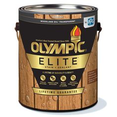 the olympic paint is shown in a wooden bucket with gold trim and an orange flame on top