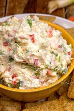 vegetable lover's cream cheese spread in a bowl surrounded by crackers