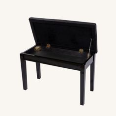 a small black bench with gold accents on it