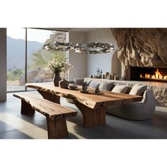 a large wooden table sitting in front of a fire place next to a wall mounted fireplace