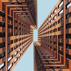 an upward view of some tall buildings