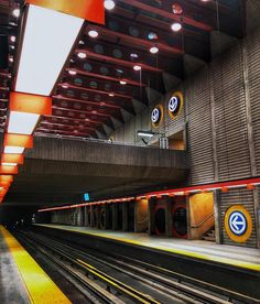 an empty train station with the lights on