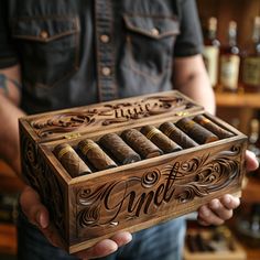 a man holding a wooden box with some cigars in it