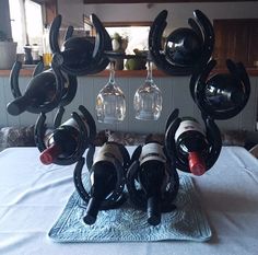 several wine bottles are placed in the shape of an octopus on top of a table