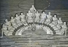 an old black and white photo of women in dresses posing for a group shot with a basketball