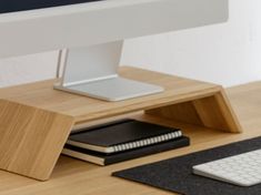 a computer monitor, keyboard and mouse on a desk