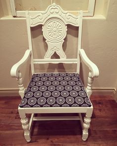 a white chair with a black seat cushion