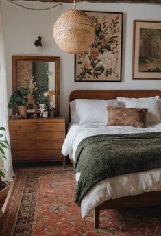 a bed sitting in a bedroom next to a wooden dresser and mirror on top of a rug