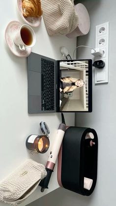 an open laptop computer sitting on top of a desk next to a cup of coffee