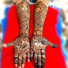 two hands with henna designs on them