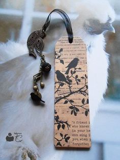 a bookmark with a bird on it and a keychain attached to it