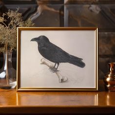 a black bird sitting on top of a wooden table next to vases with flowers