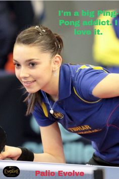 a girl is smiling while playing ping pong