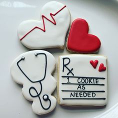 three decorated cookies on a plate with stethoscope and doctor's notes