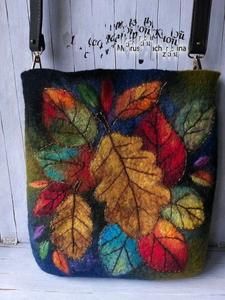 a handmade purse with colorful leaves on it