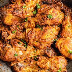 chicken wings in a skillet with parsley on top