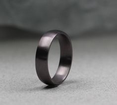 a close up of a wedding ring on a gray surface with no one in it