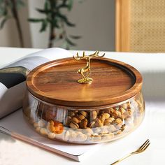 a wooden tray filled with nuts on top of a table