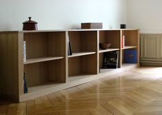 an empty room with some bookshelves and other items on the shelves in it