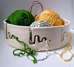 two balls of yarn are in a white basket