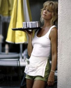 a woman is holding a cake on a tray