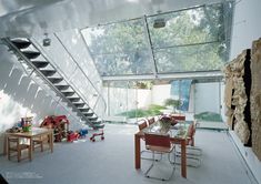 a dining room table and chairs under a glass roof