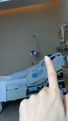 the hand is pointing at the hospital bed