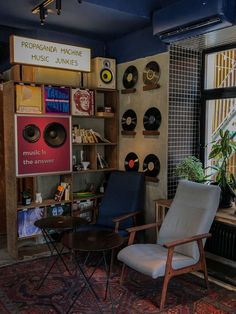 a room filled with furniture and records on the wall