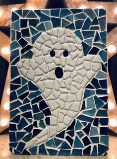 a mosaic with lights around it in the shape of an elephant