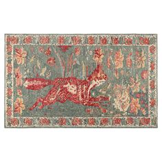 a rug with an animal on it and flowers in the middle, along with other items