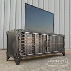 a large television sitting on top of a metal cabinet